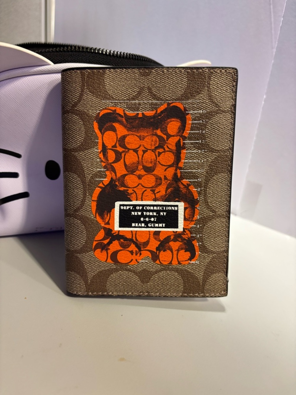 Coach Brown Passport Wallet with Orange Bear Graphic